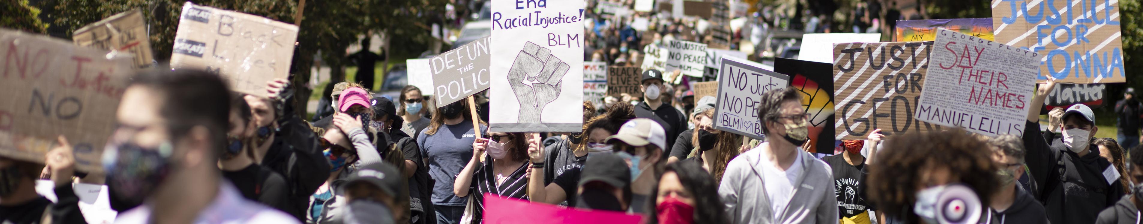 A group of protesters marching with signs