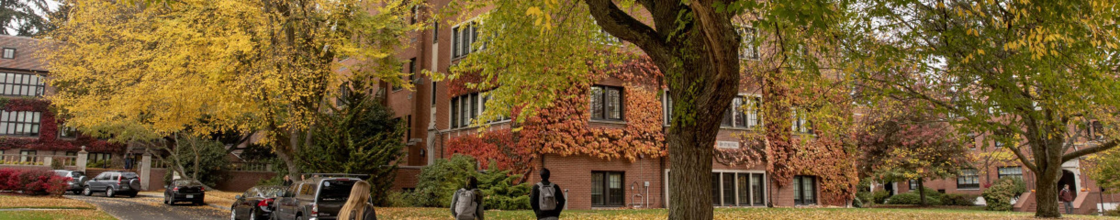 People walking through campus during Fall season colors
