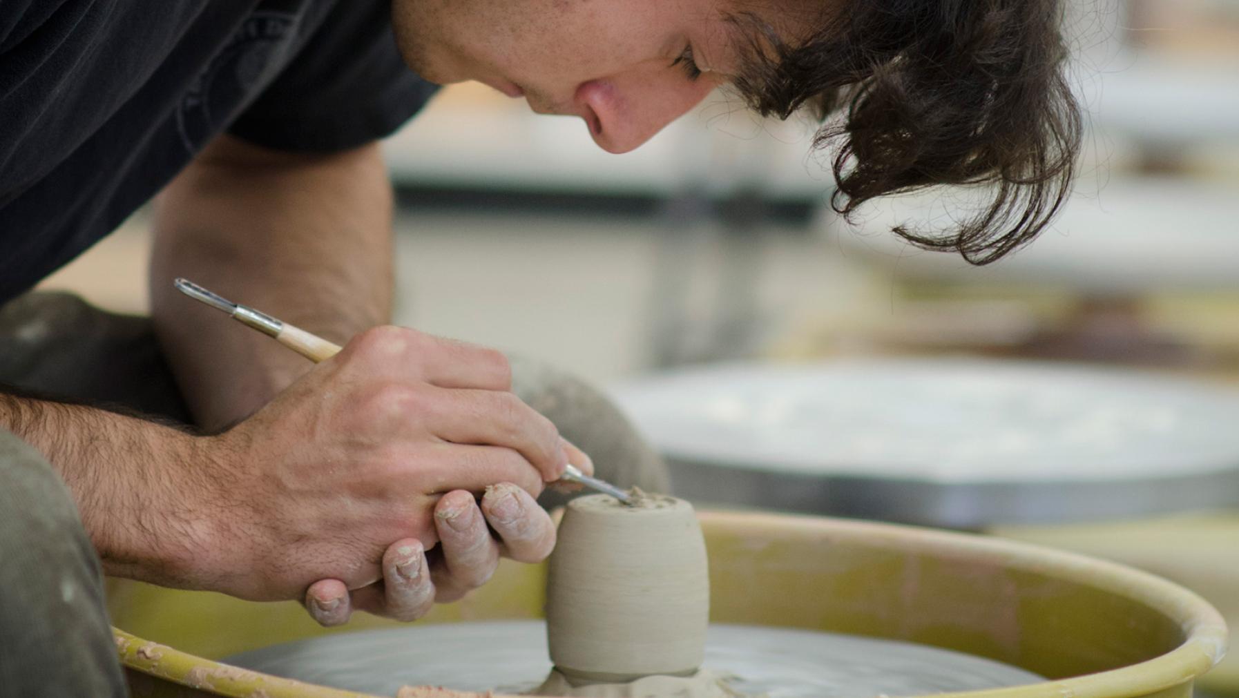 Student crafting a ceramic piece