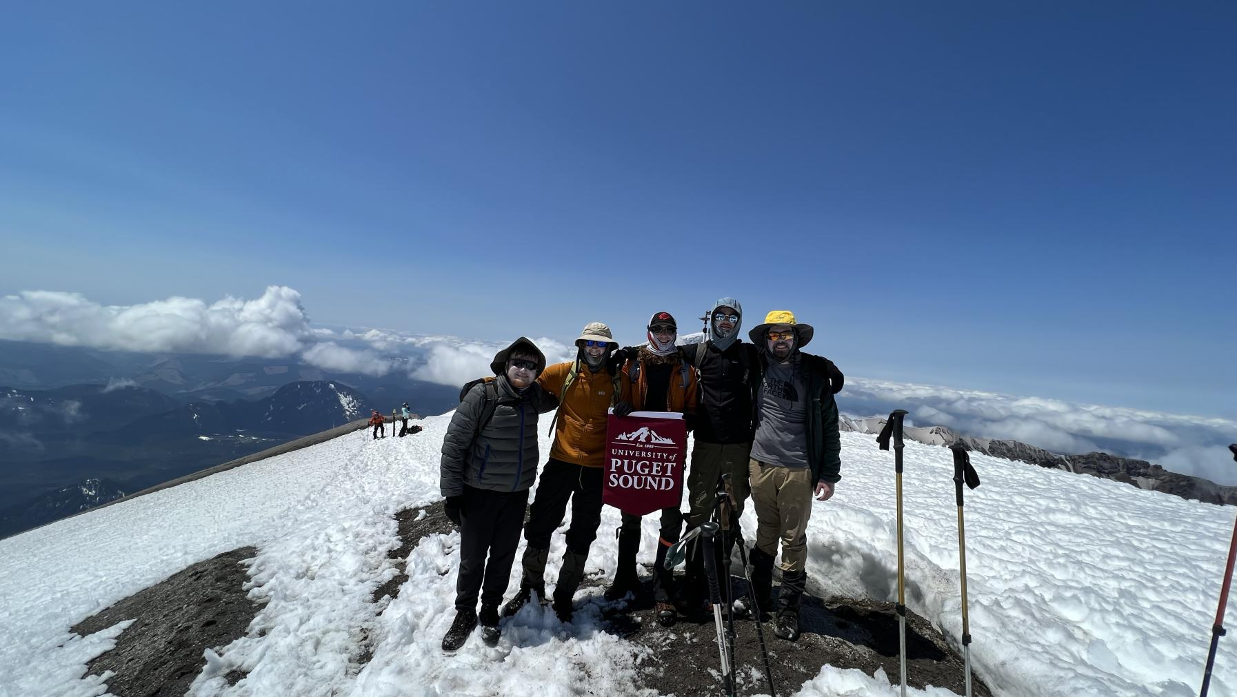PacTrail students display a Puget Sound banner at the summit of Mount St. Helens.