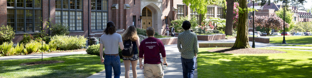 A group of people walking towards a building