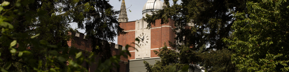 A brick building with a large clock face