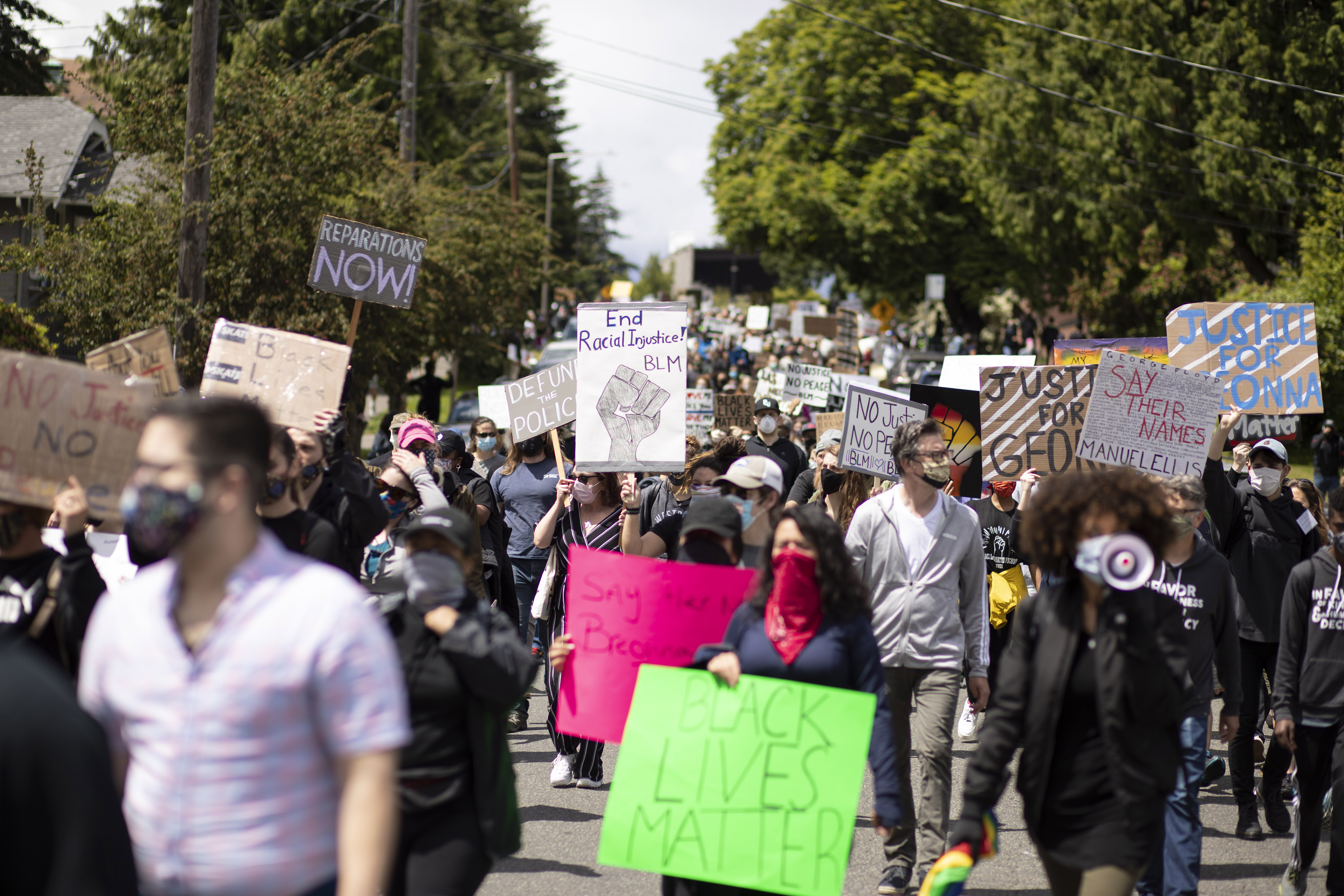 A group of protesters marching with signs