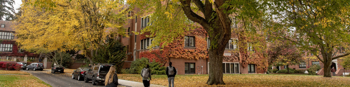 People walking through campus during Fall season colors