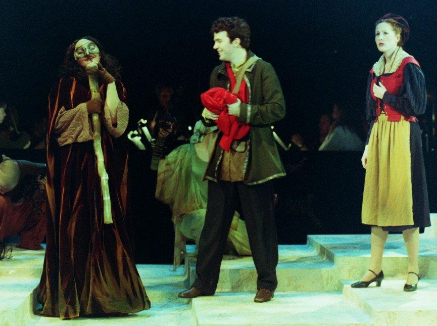 Three actors on a stage in a play