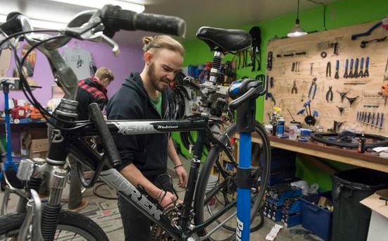 A person working on repairing bikes in a bike shop