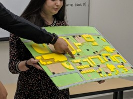 A person holding a tactile map of the university campus