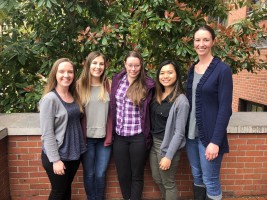 A group of five people posing for a photo