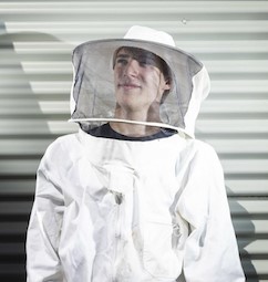 Beekeeper wearing protective bee suit