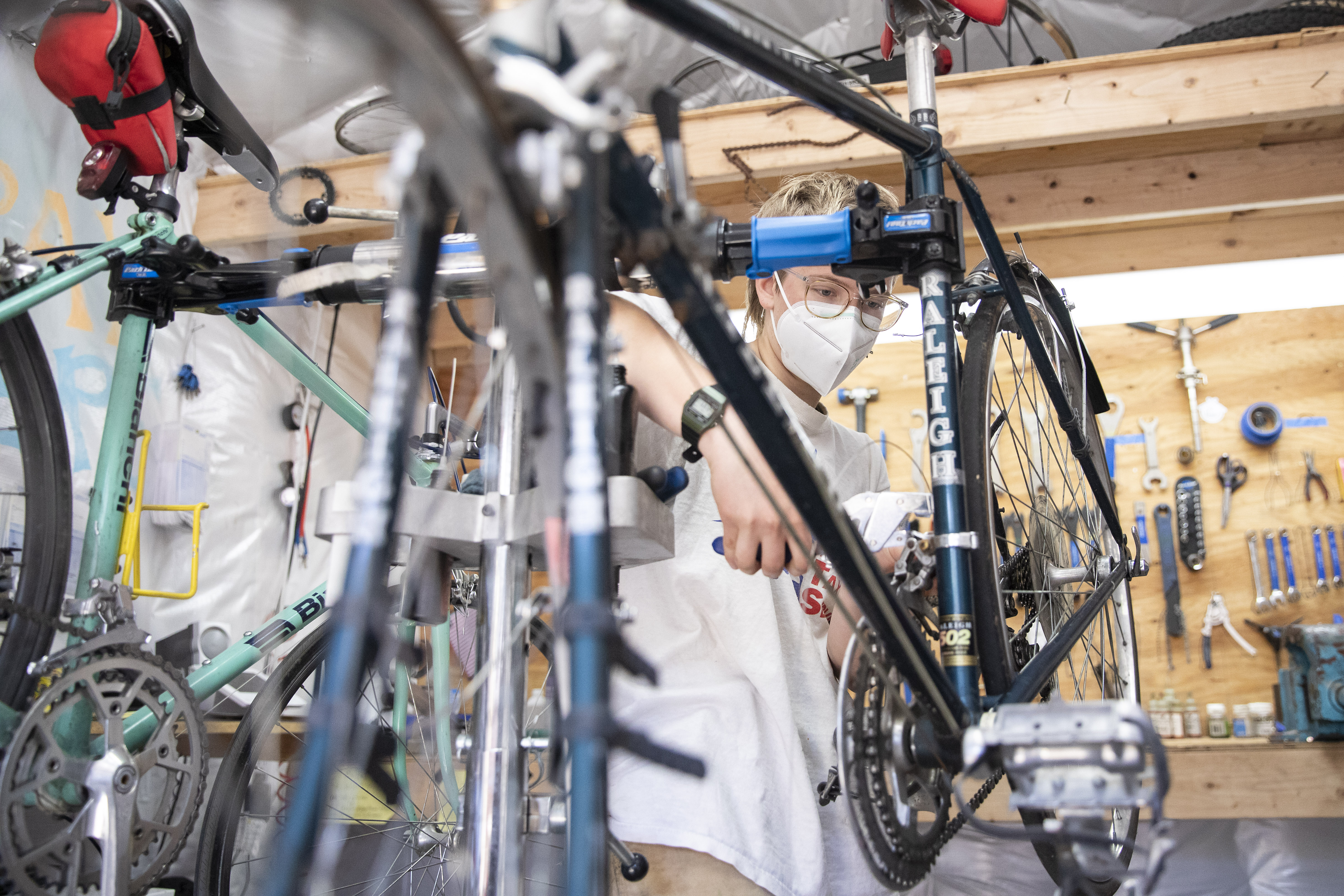 A student performing maintenance on a bike.