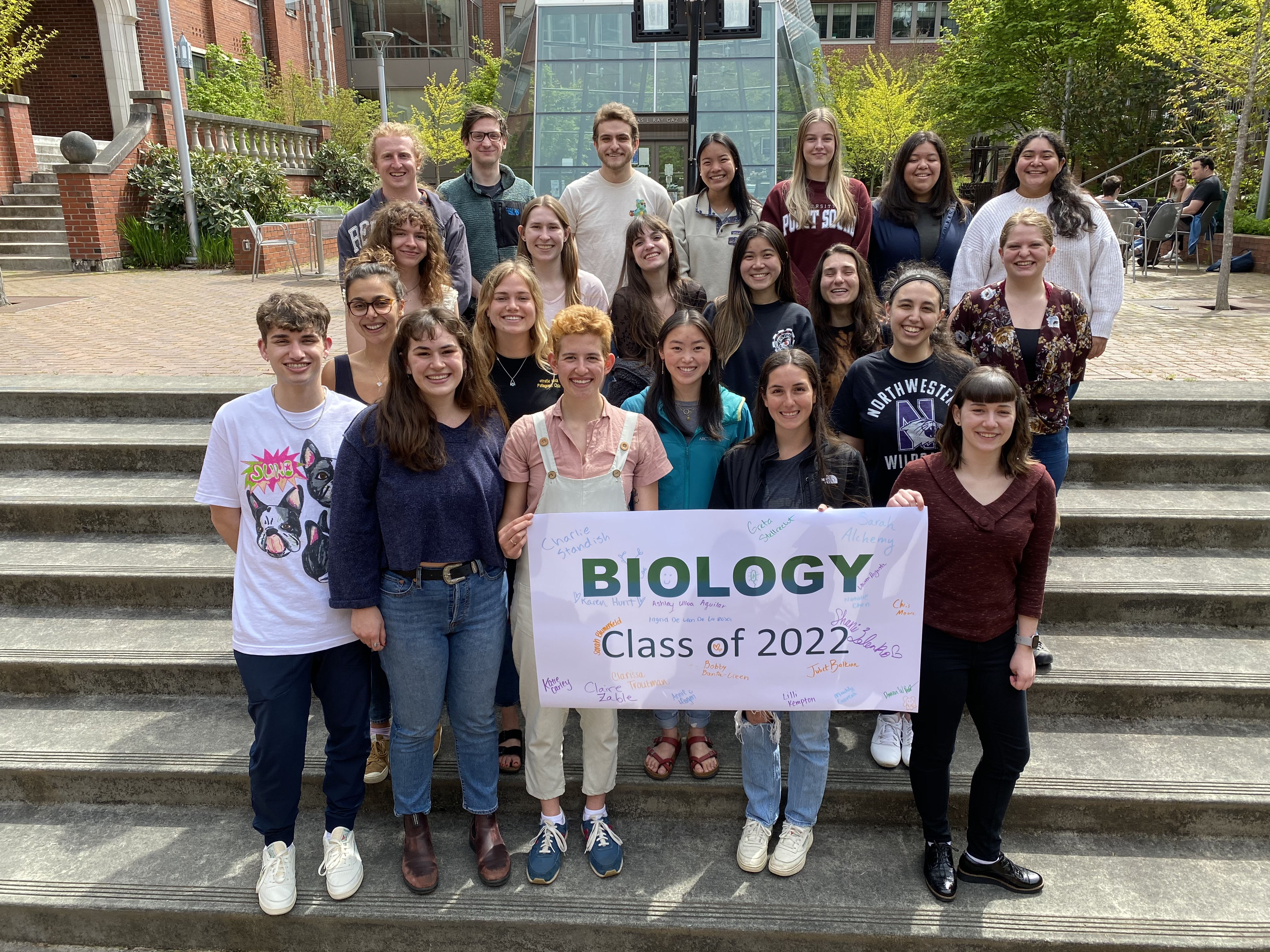 Biology students gathered for group photo holding Class of 2022 sign