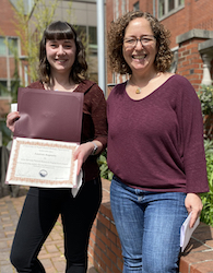 Lauren Augusta receiving award from Stacey Weiss