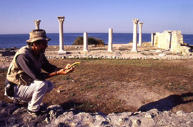 Man kneeling in archaeological site