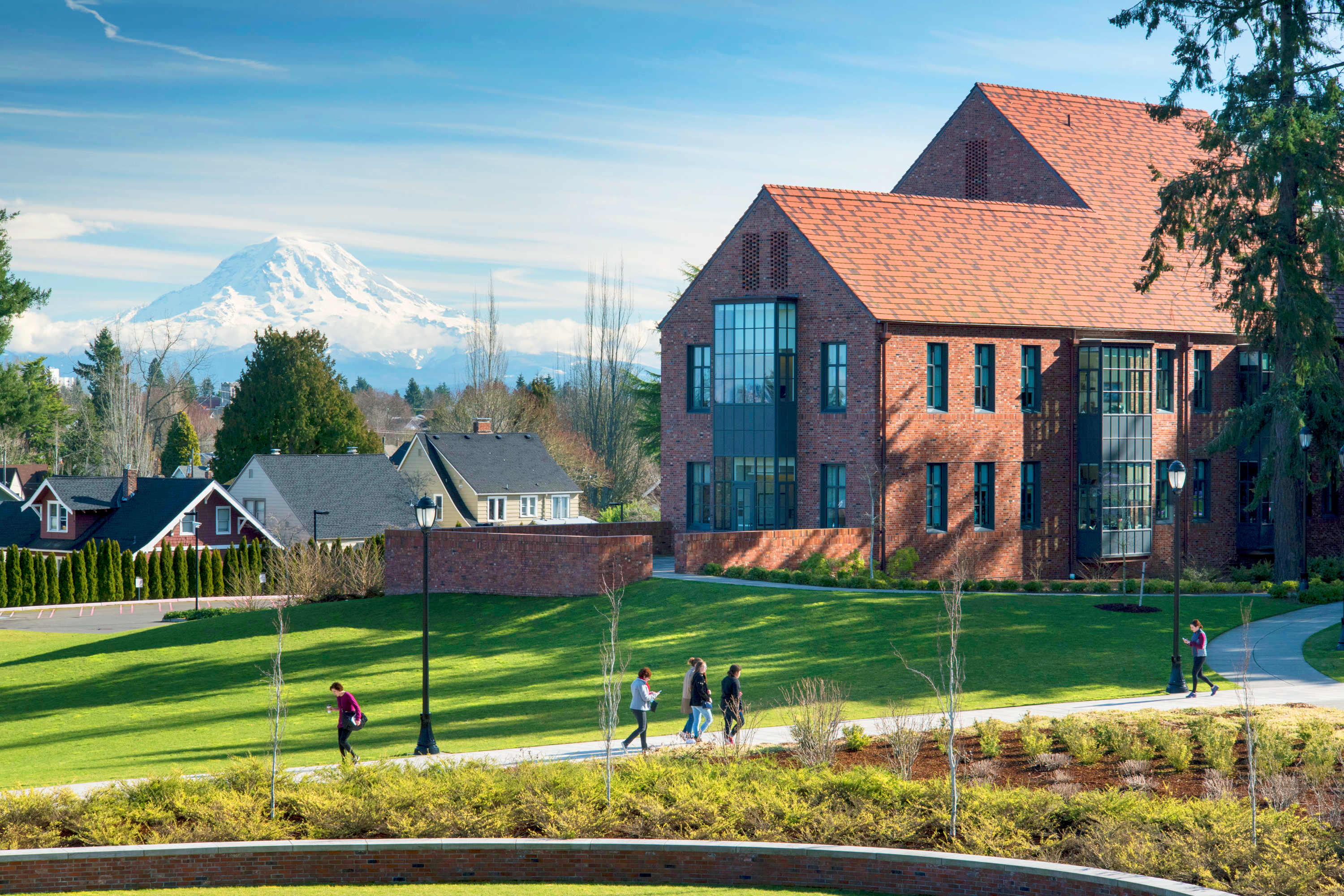 Students walking in front of Weyerhauser Hall with Mt. Rainier in the background