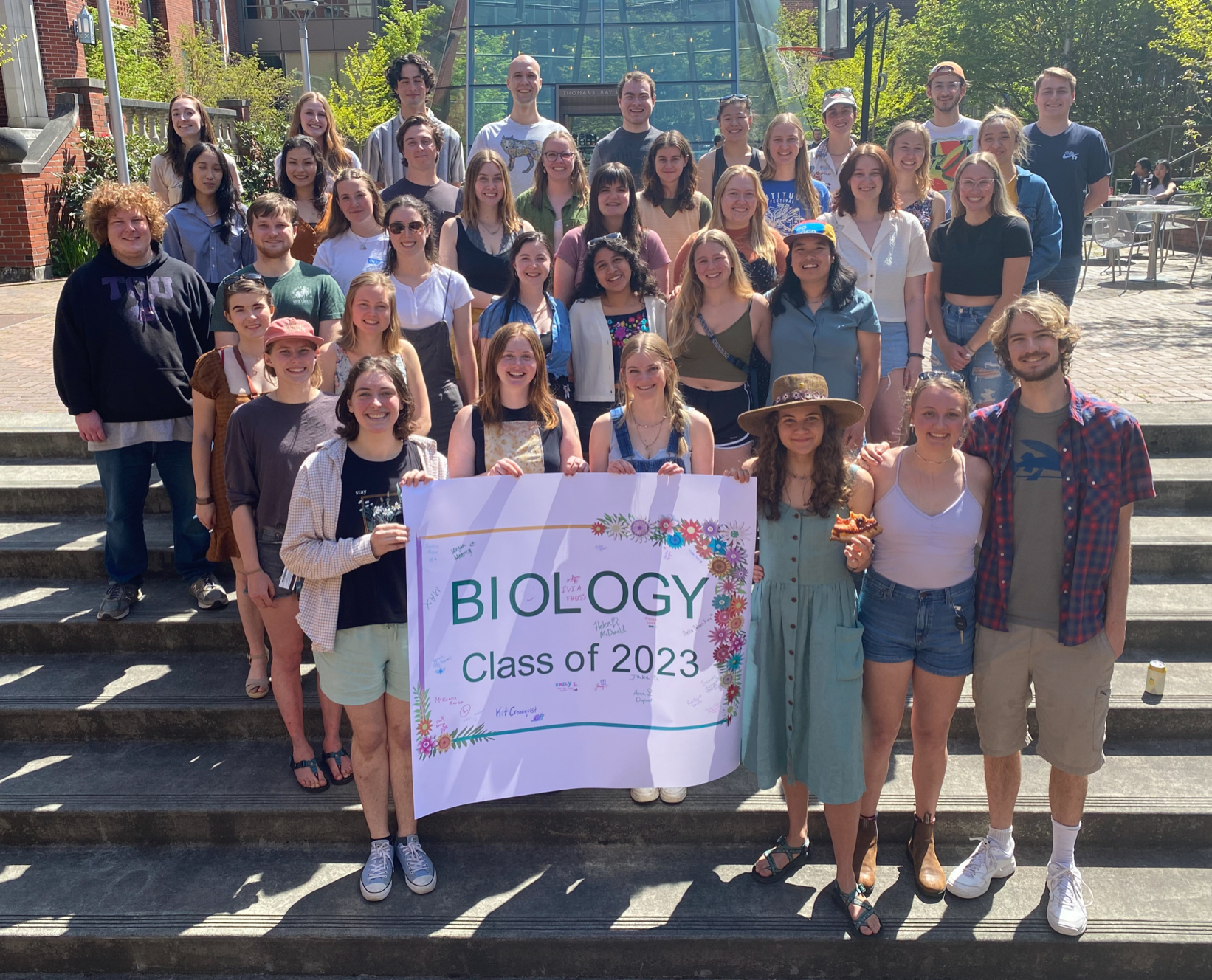 Biology students gathered for group photo holding Class of 2023 sign