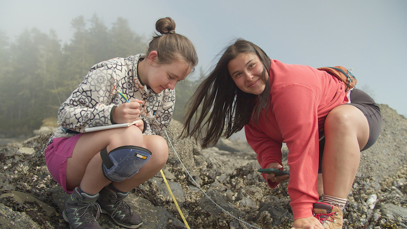 Kaia Doan and Olivia Brech collecting data on the beach