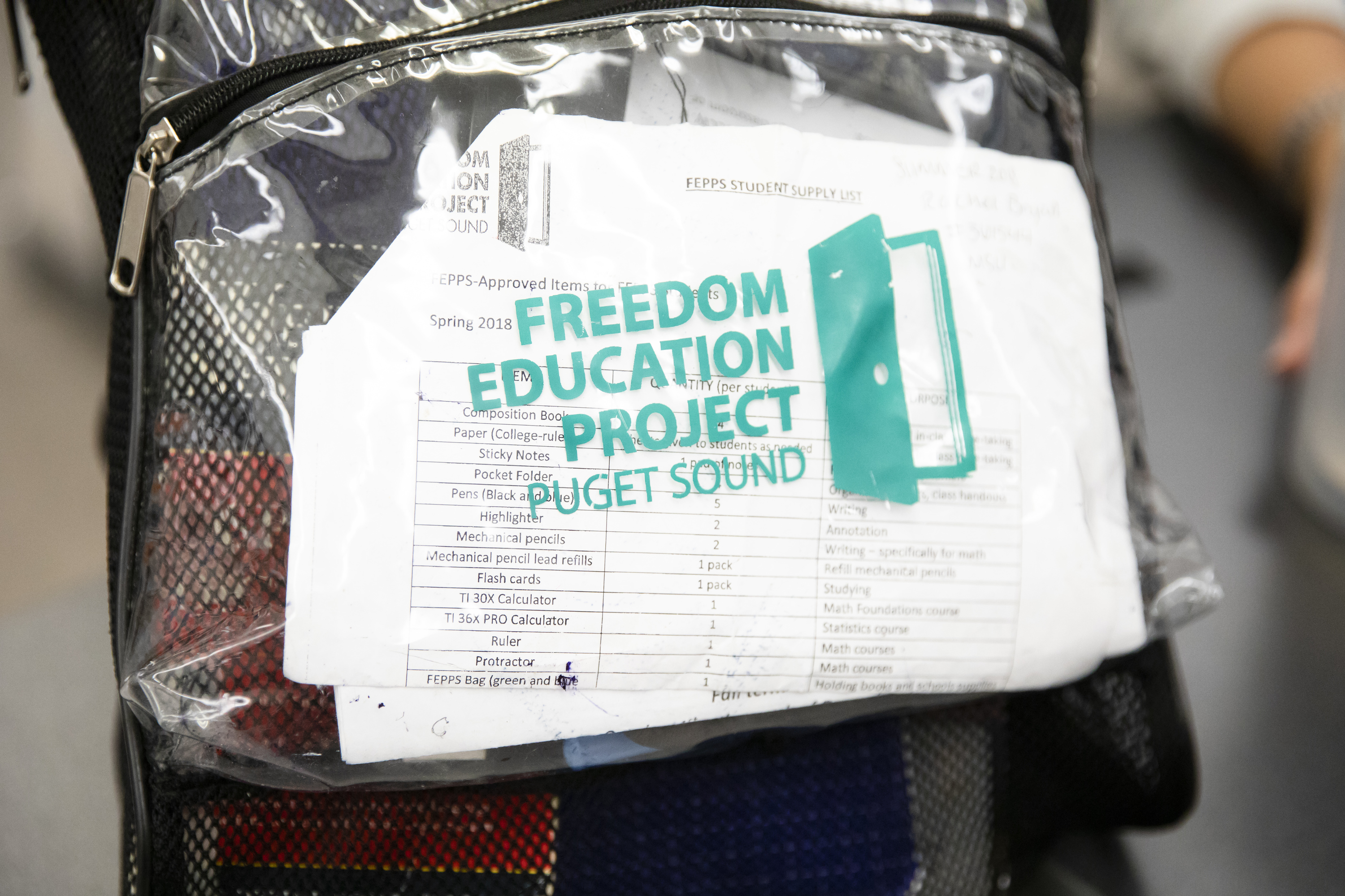 A clear bag with the words Freedom Education Project Puget Sound in green on the exterior. 