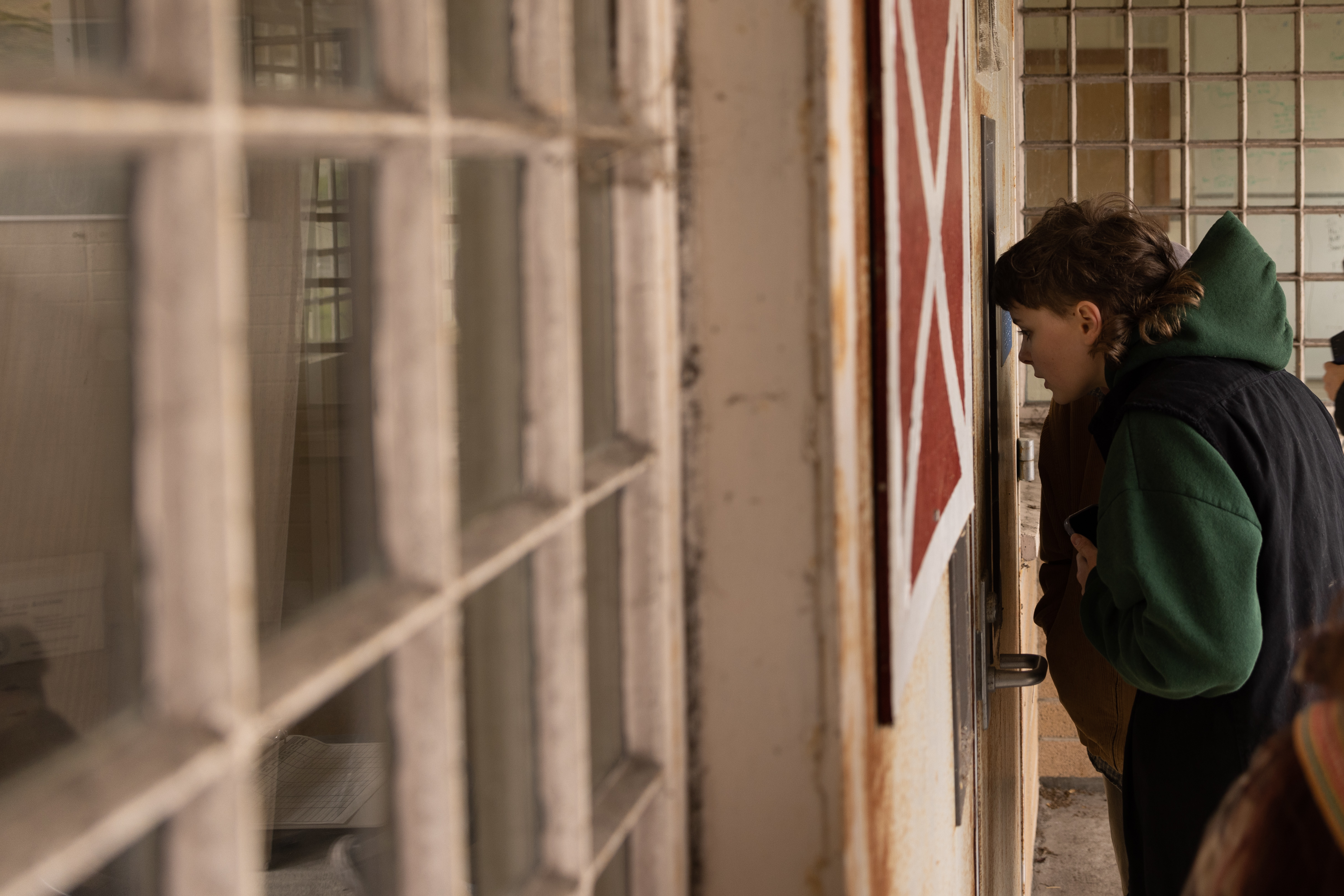 A student looked through bars at a jailhouse. 