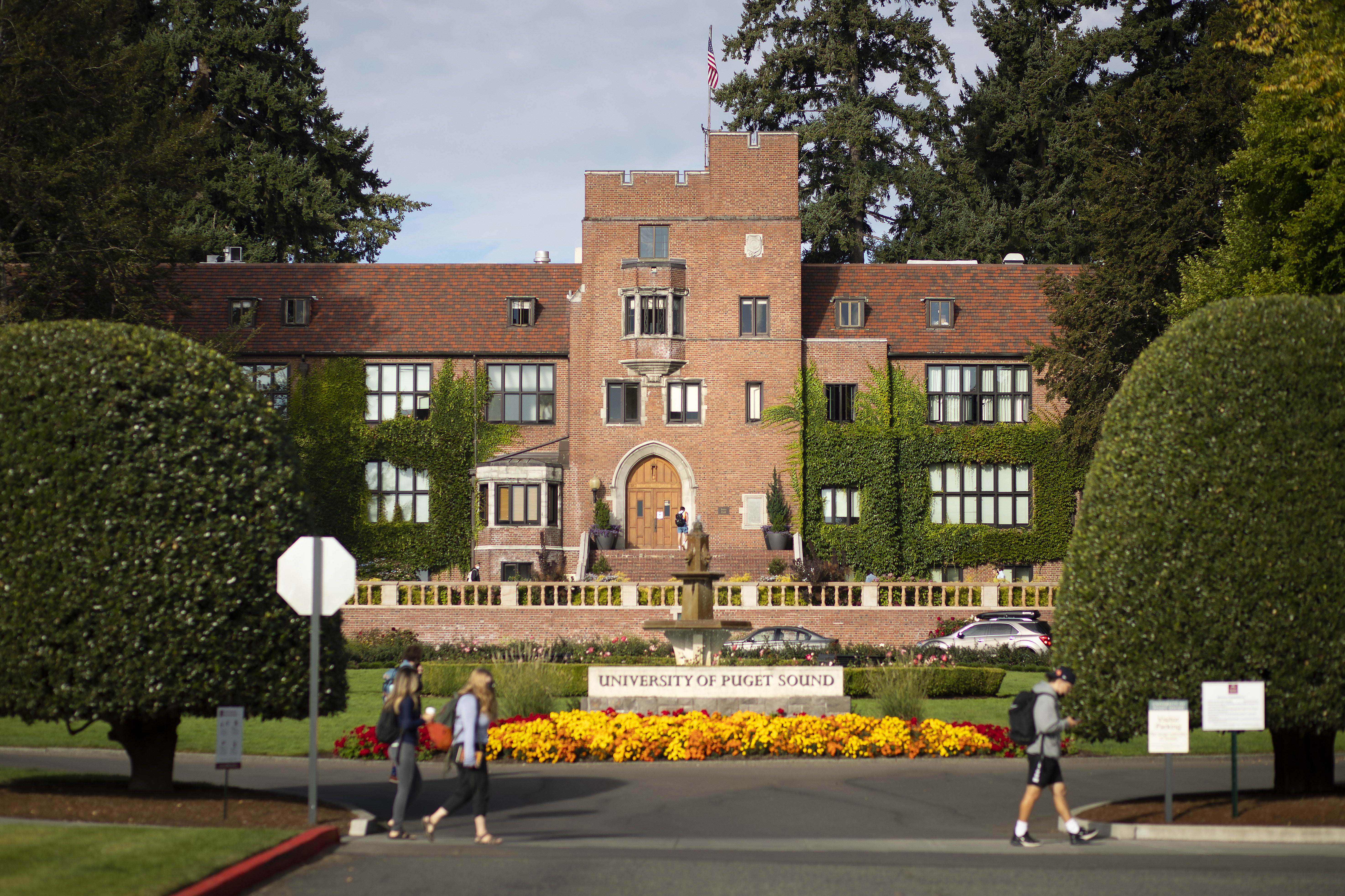 Jones Hall sits behind a flower garden on campus. 