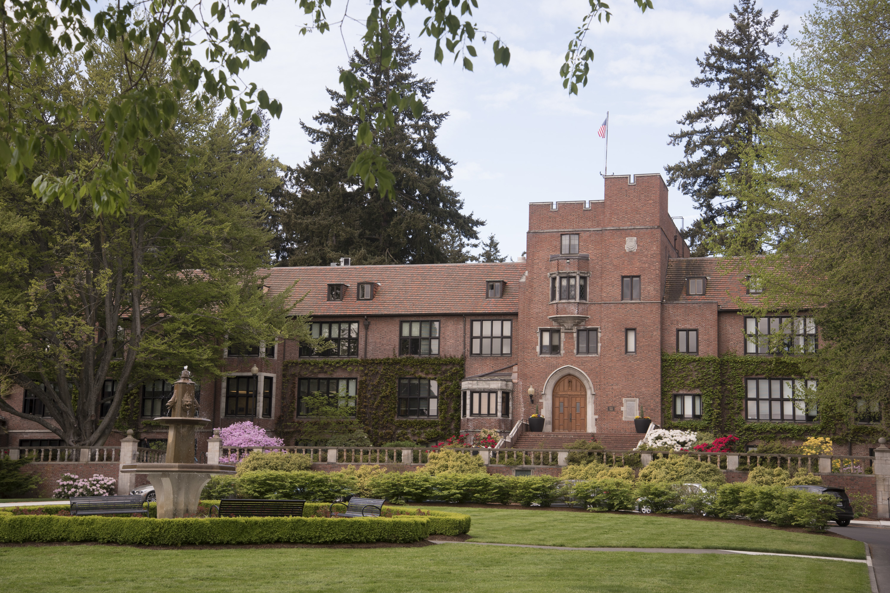 Jones Hall sits behind a flower garden on campus. 