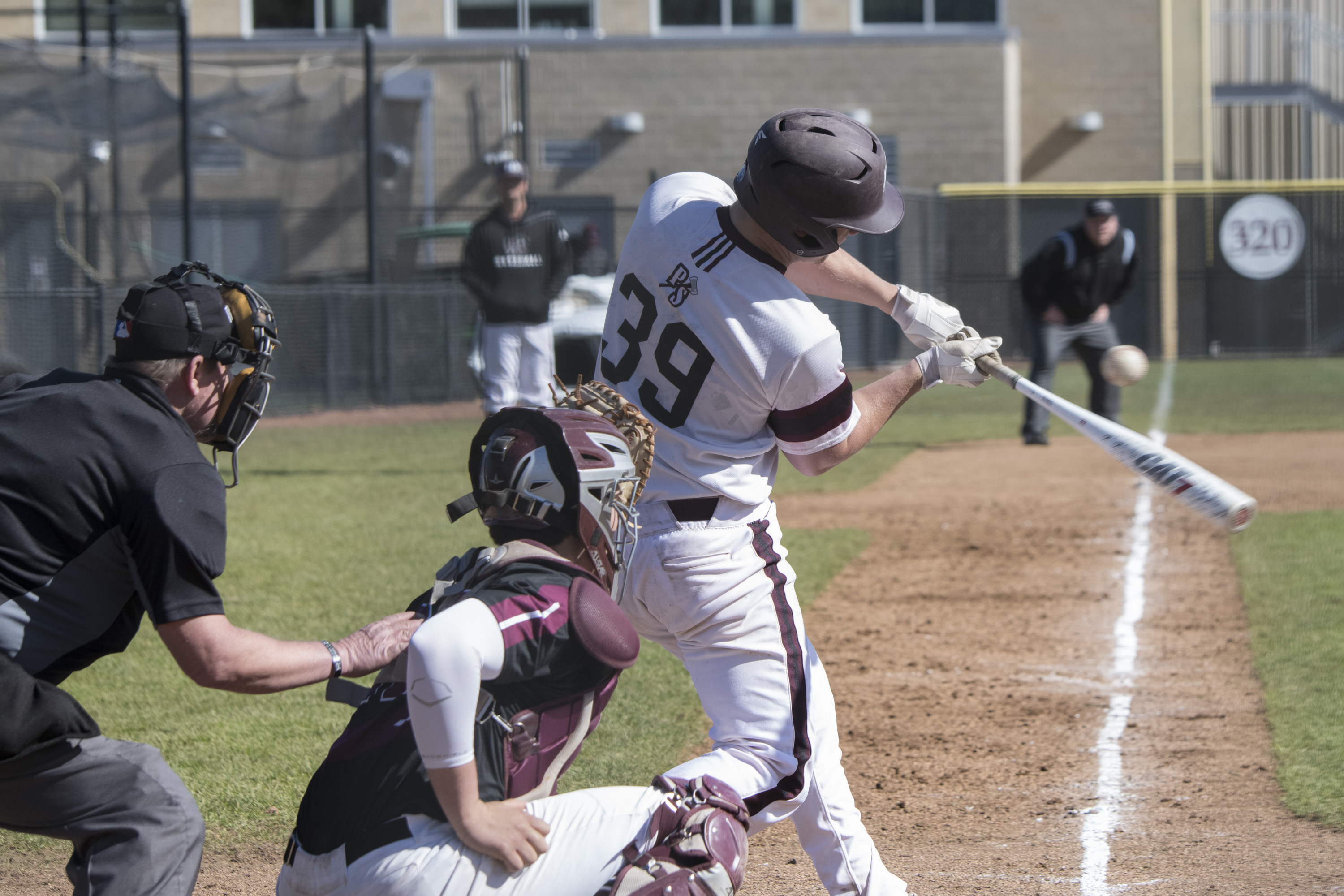 Baseball player striking a ball