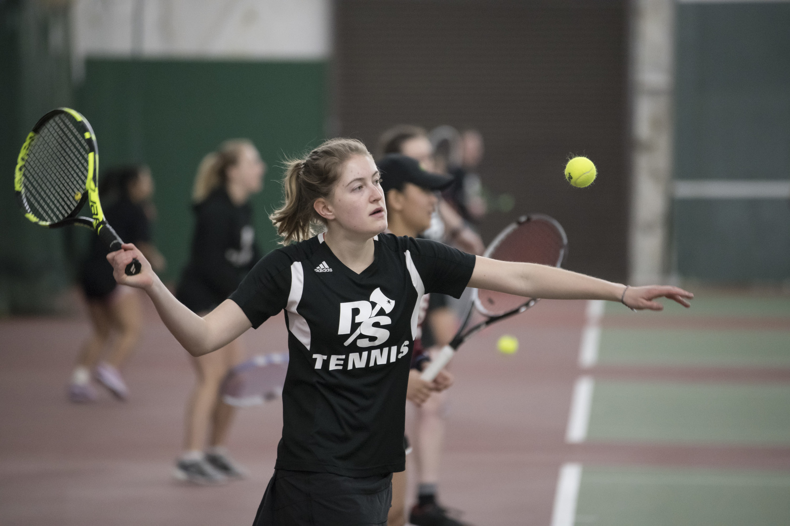 Player striking a tennis ball in the pavilion