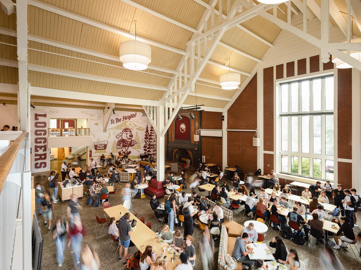 Students sit at tables inside Wheelock dining room. 