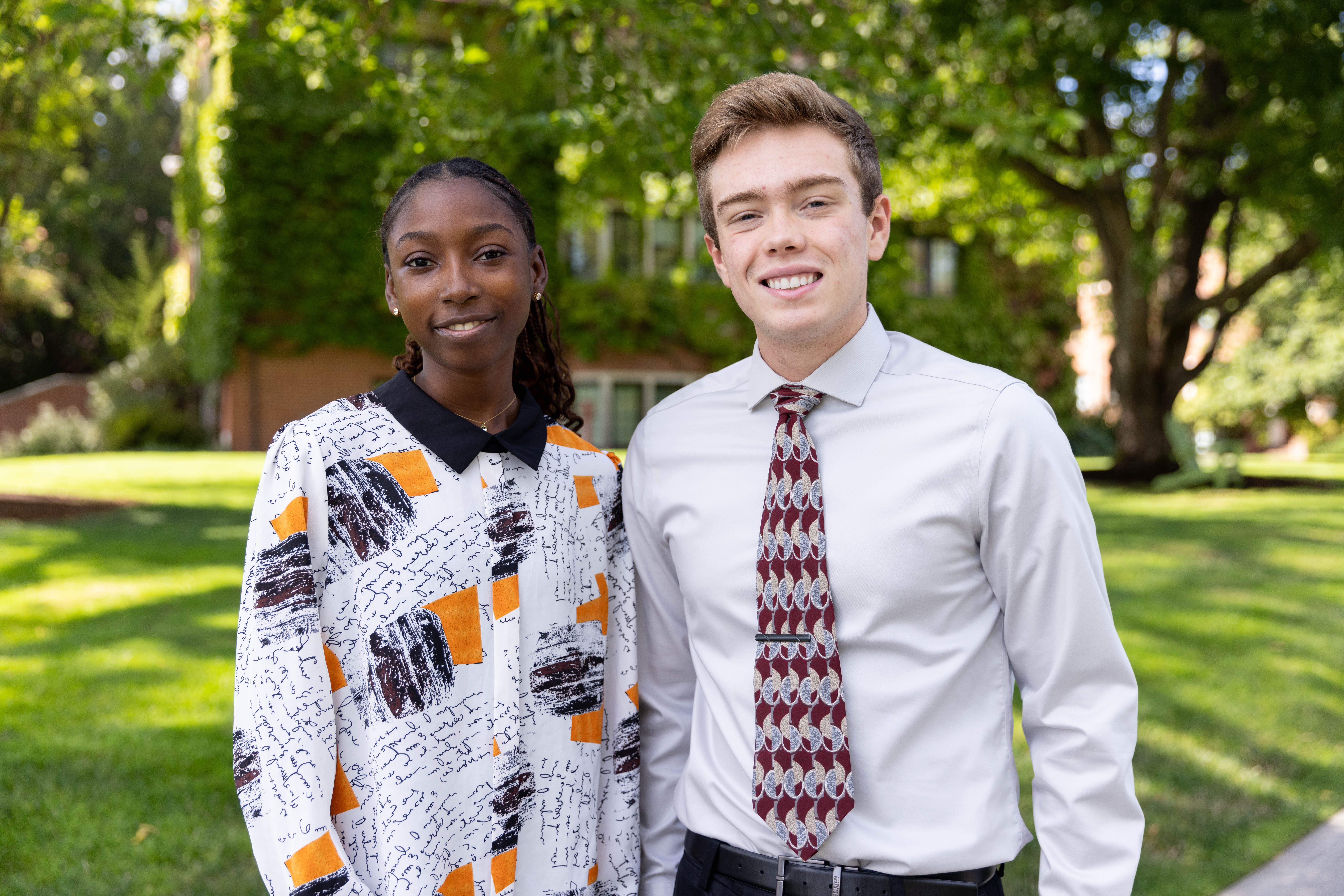 Esther Mosaku stands beside Bryce Kirk on the university campus. 