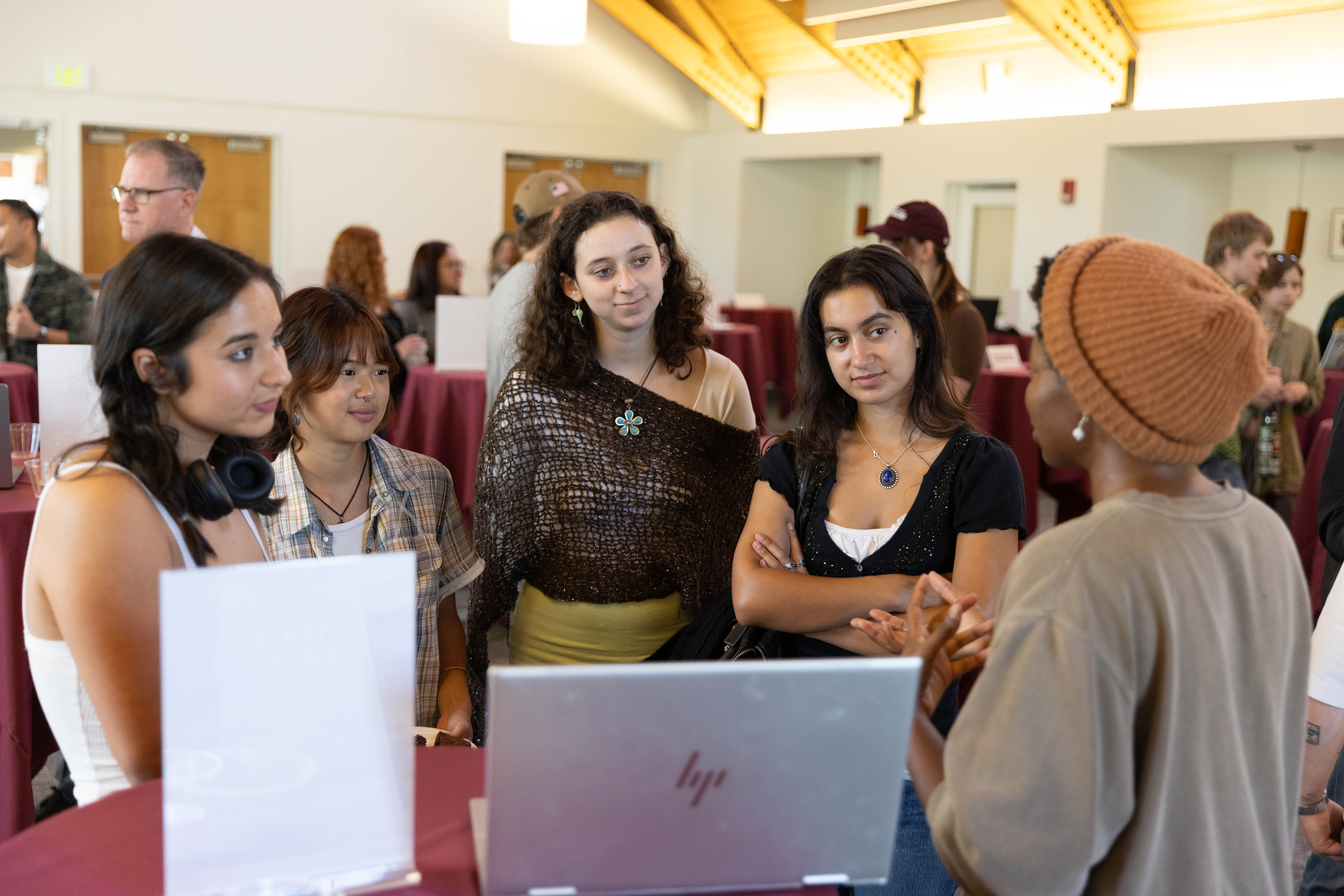 Students listen to a presentation at Experiential Learning's Summer Internship Symposium in 2024.