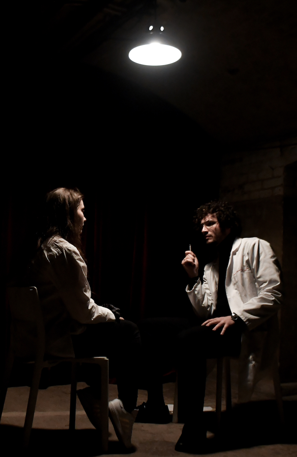 Two people sitting in chairs across from one another