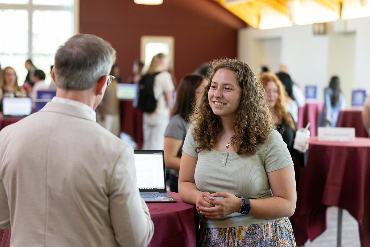 Sophia Haynes ’27 speaks to Provost Drew Kerkhoff at the Summer Internship Symposium in Fall 2024.