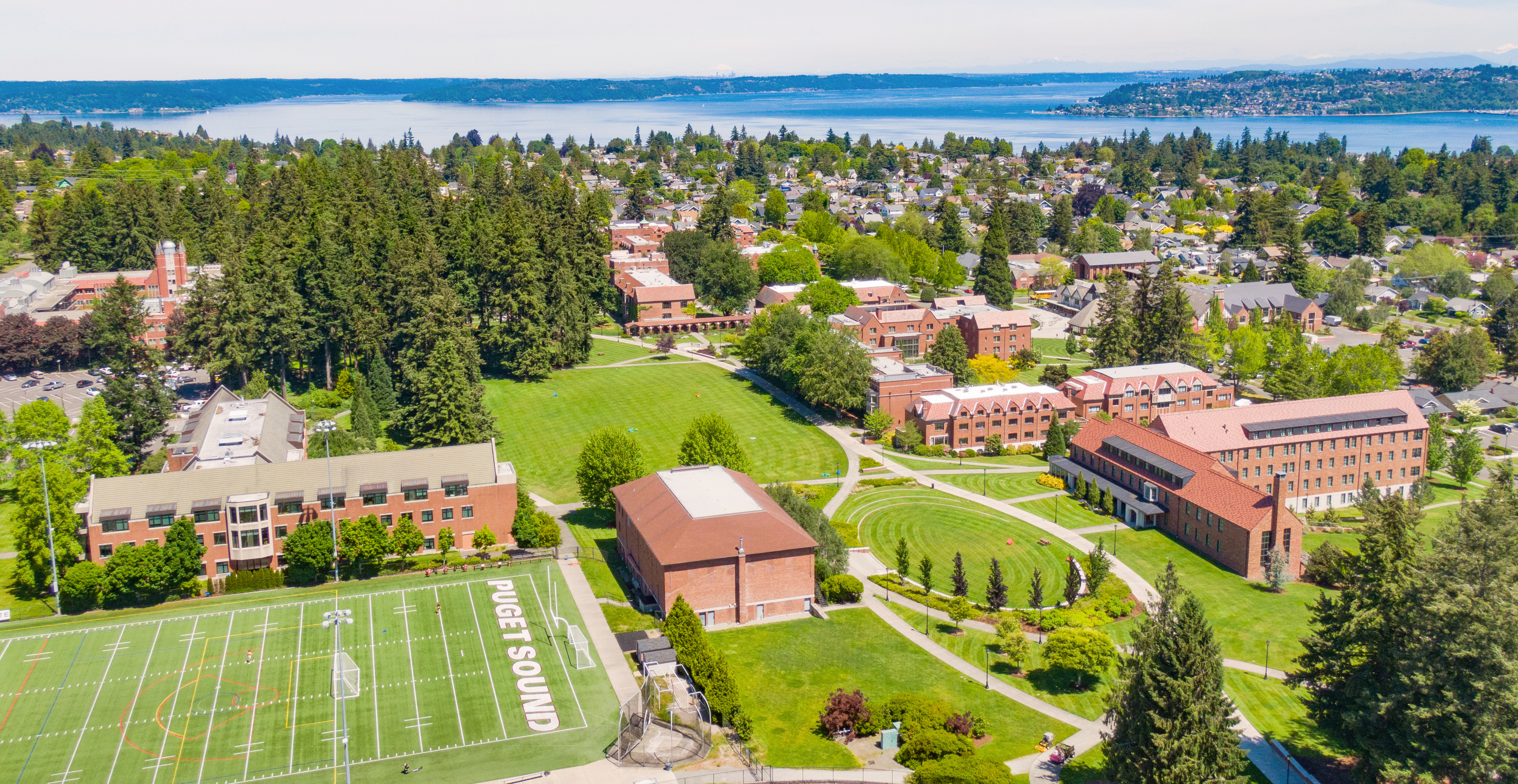 Aerial image of campus with red brick buildings and trees.