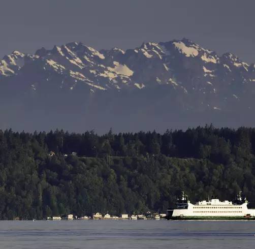 Washington State ferry on the Puget Sound with mountains and trees behind
