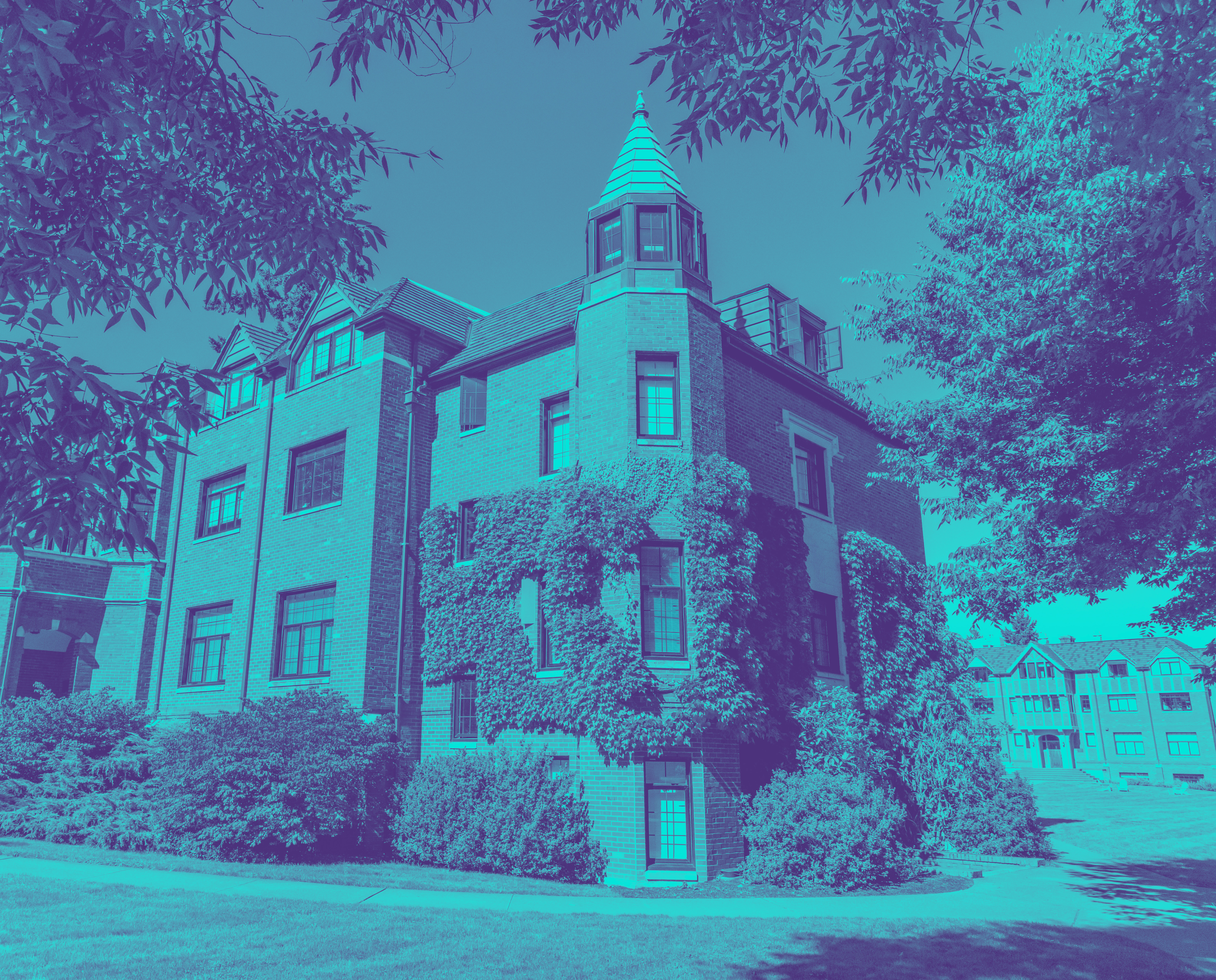 Blue and purple tonal image of a brick building with ivy growing on it.
