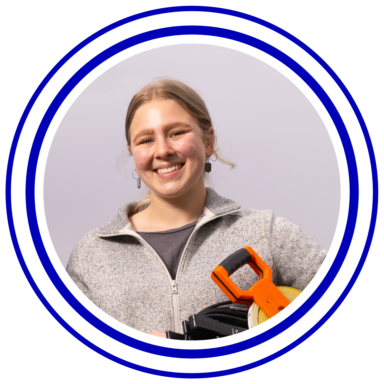 Circular image with colorful rings around it of Megan Mooney.