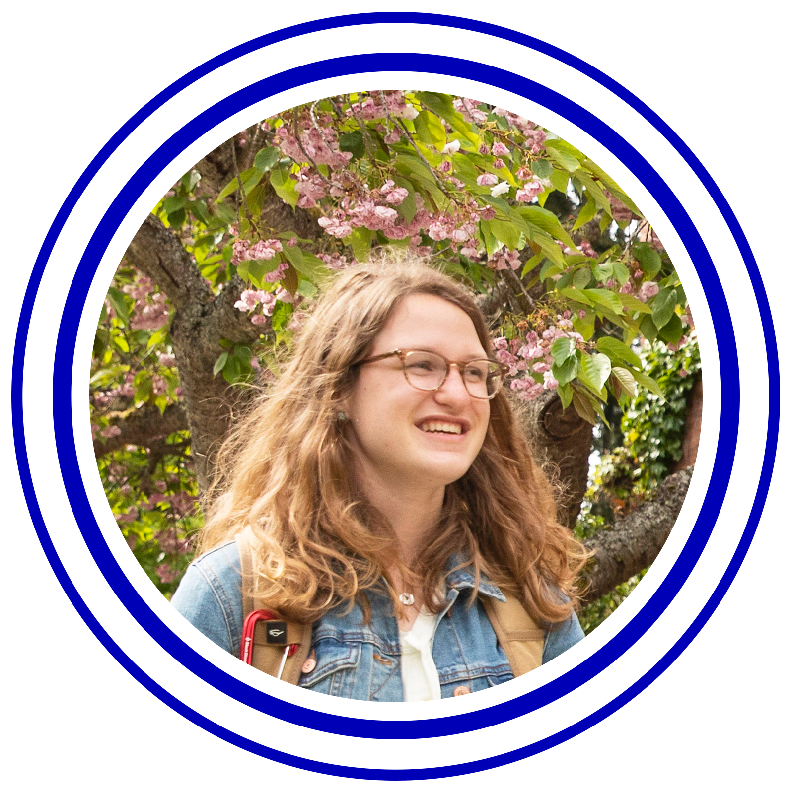 Circular image with colorful rings around it of Olivia Almy.
