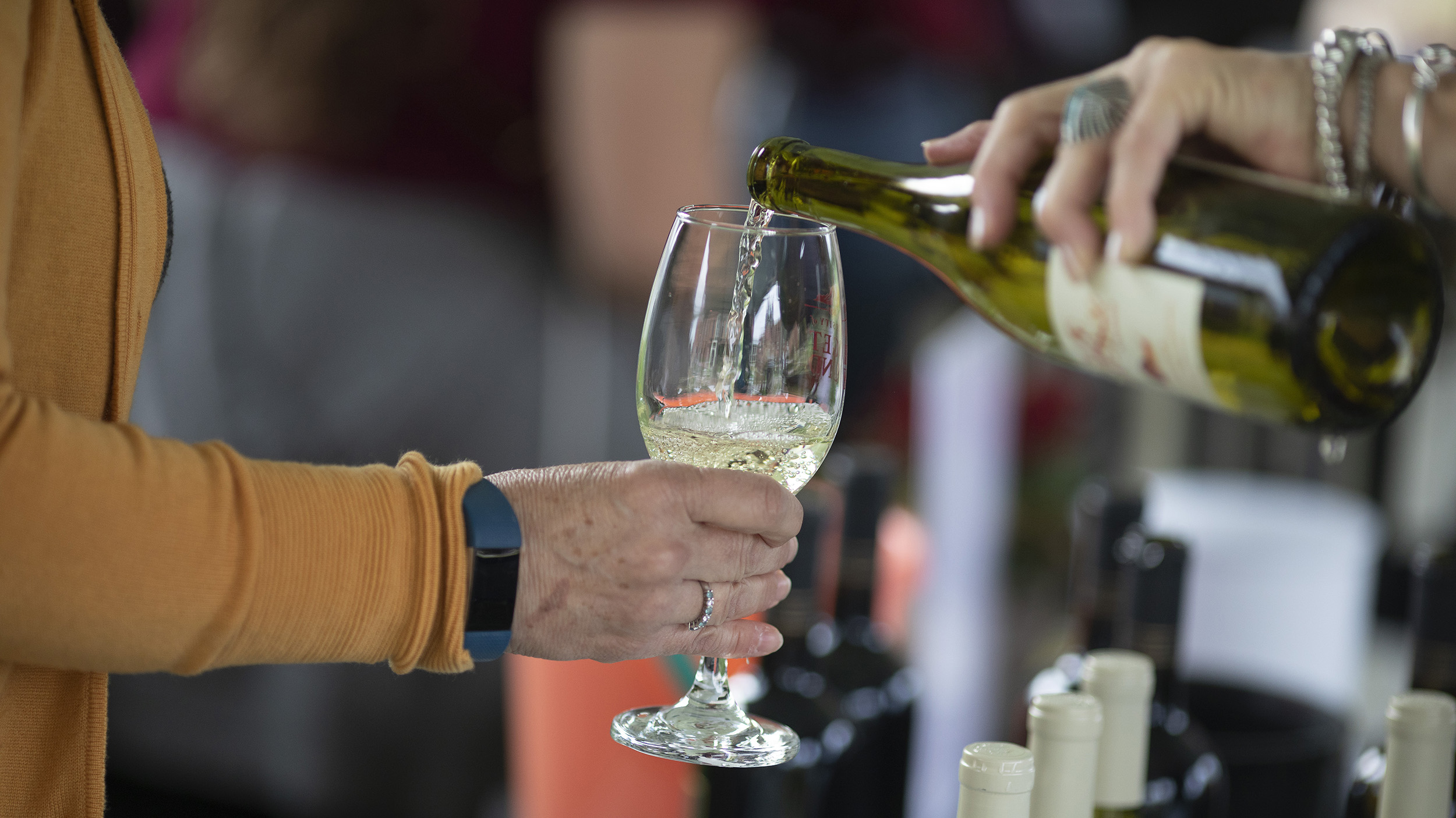 White wine pouring into a wine glass.