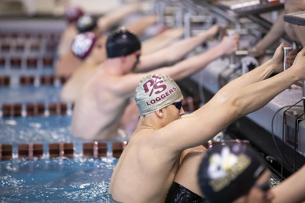 Swimmers prepare to push off the wall. 
