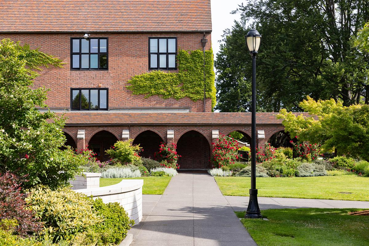 Brick building with black lampost in the foreground. 