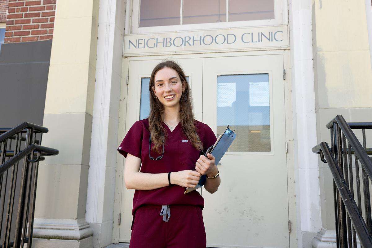 Cecilia Turetzky stands in front of the Neighborhood Clinic building.