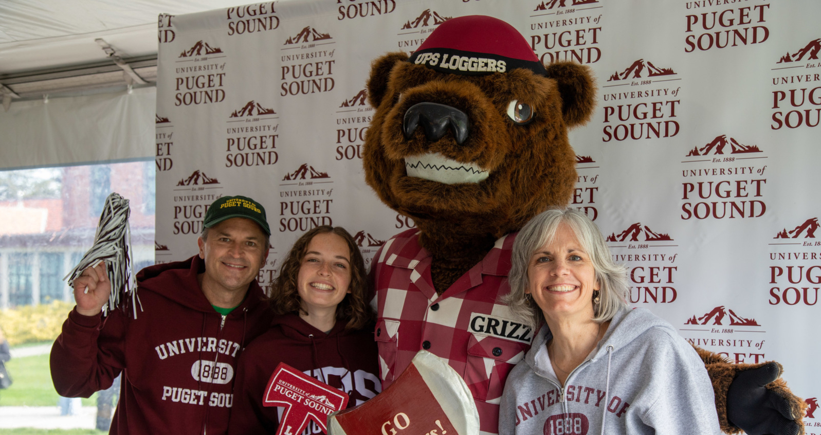 Logger fans pose with Grizz 