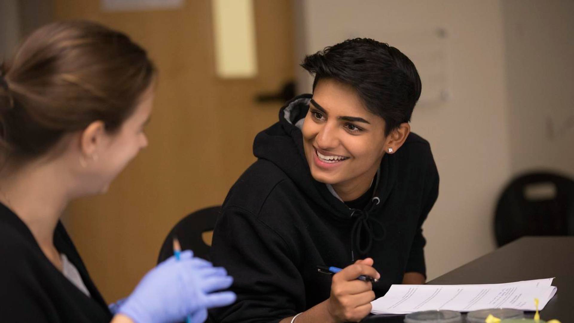 Two students collaborate in a classroom.