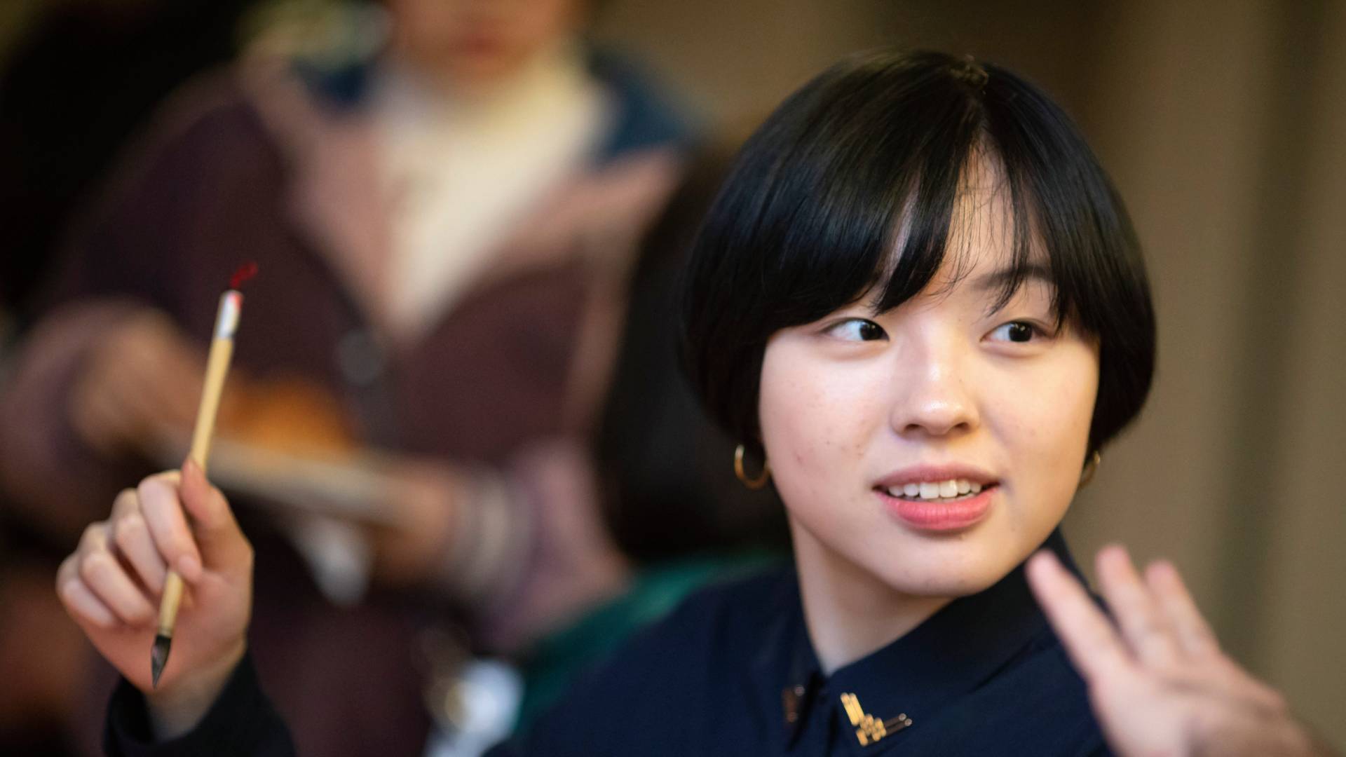 A student participates in a Lunar New Year celebration.