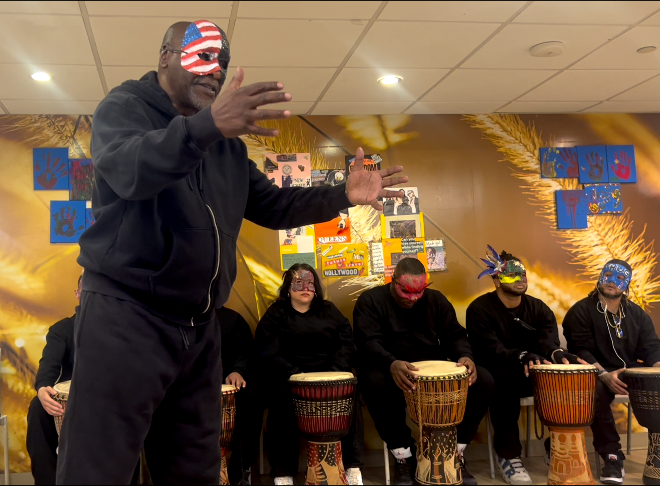 Alex Anderson stands in front of a group