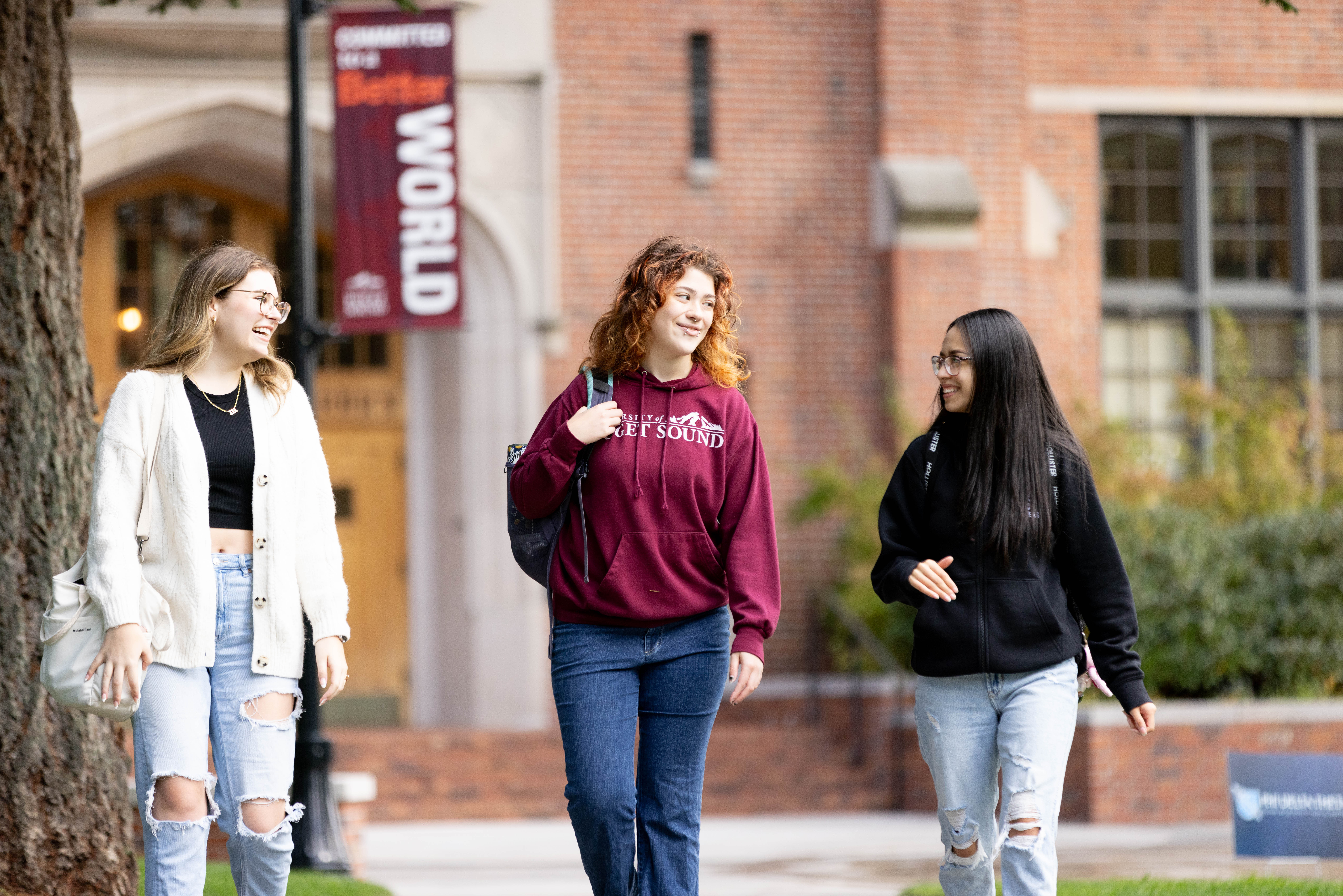Three students walking on campus