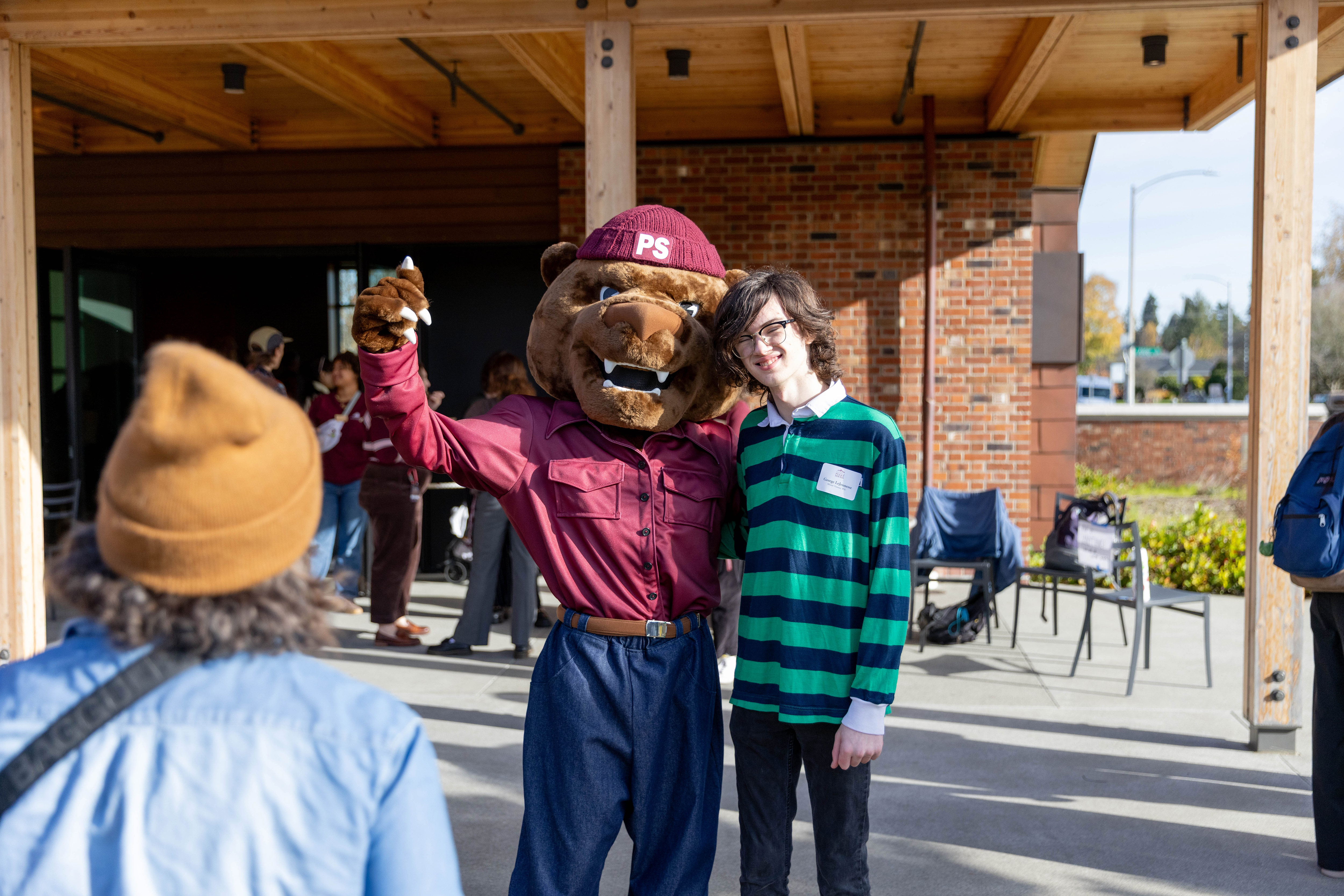 Mascot, Grizz, poses with a prospective student during the Fall 2025 Discover Puget Sound Event.