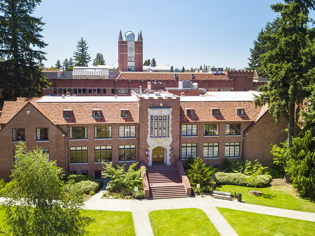 A red brick building with an observatory behind it.