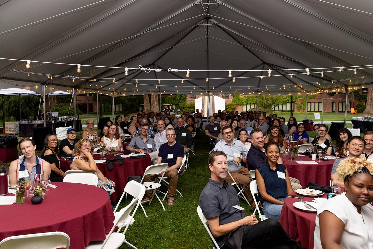 faculty sit at tables 