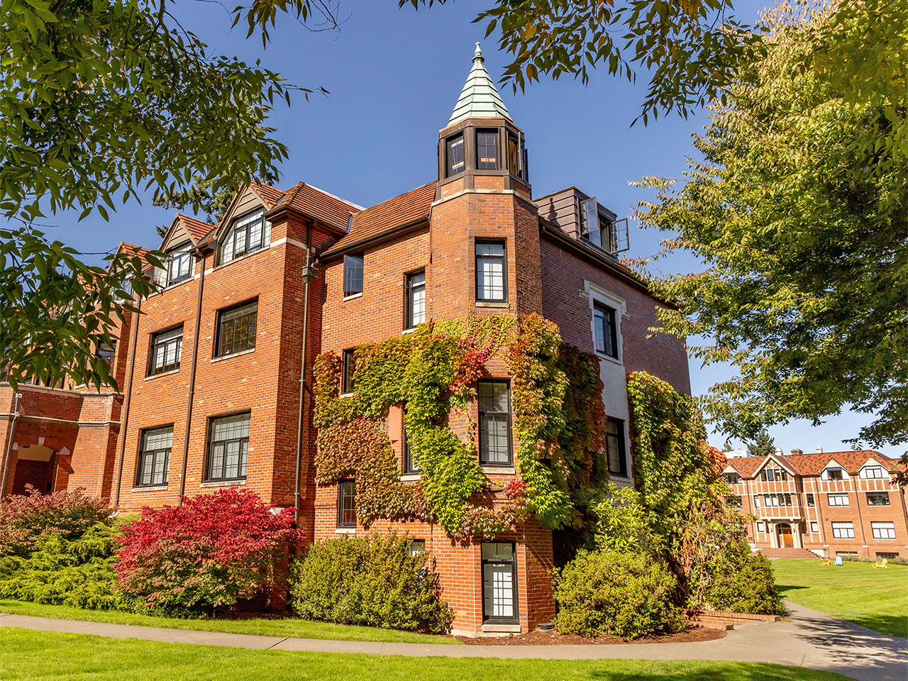Red brick building with ivy growing on it.