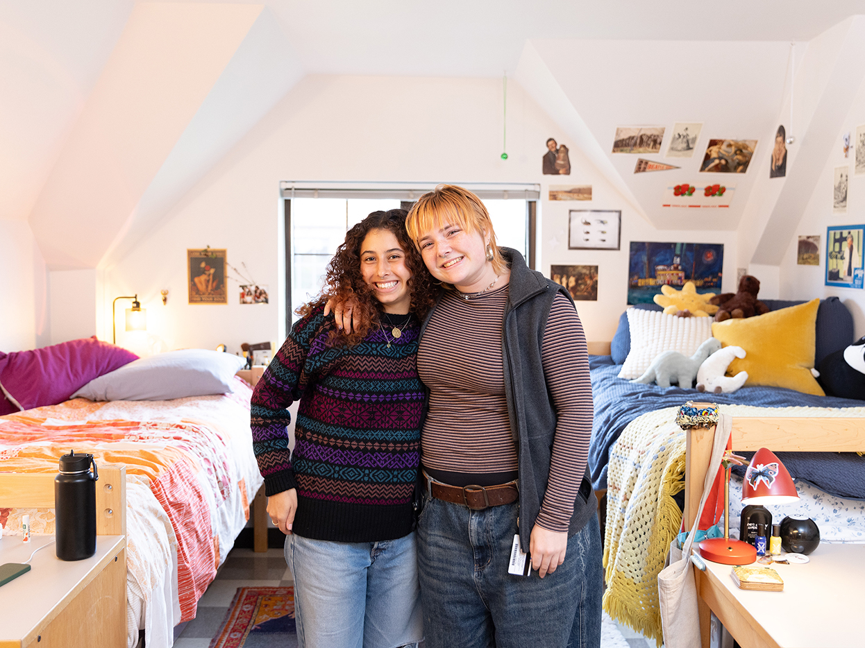Two students side hugging in their residence hall